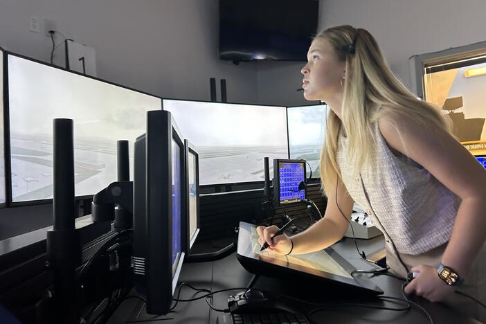Hailee Williamson stands behind the controls of an air traffic control simulator at Embry-Riddle Aeronautical University in Daytona Beach, Fla.