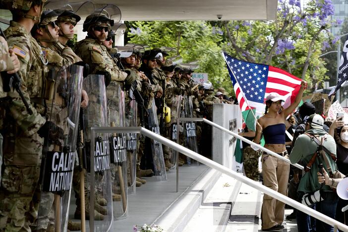Protesters stand off against California National Guard soldiers at the Federal Building in downtown Los Angeles during a "No Kings" protest on Saturday.