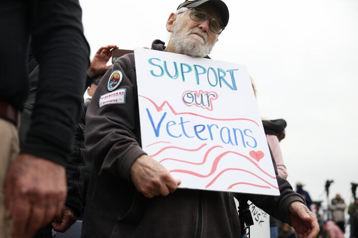 John Spitzberg, 87, holds a "Support our Veterans" sign during a veterans march at the National Mall on March 14 in Washington, D.C. The 87-year-old veteran was arrested June 13 at the U.S. Capitol while protesting the U.S. Army's 250th anniversary parade, which coincided with President Trump's 79th birthday.