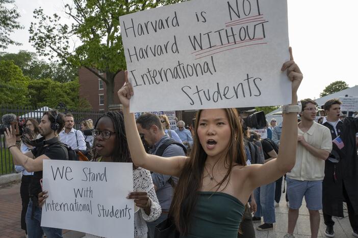 People hold up signs during the Harvard Students for Freedom rally in support of international students at the Harvard University campus in Boston in May.