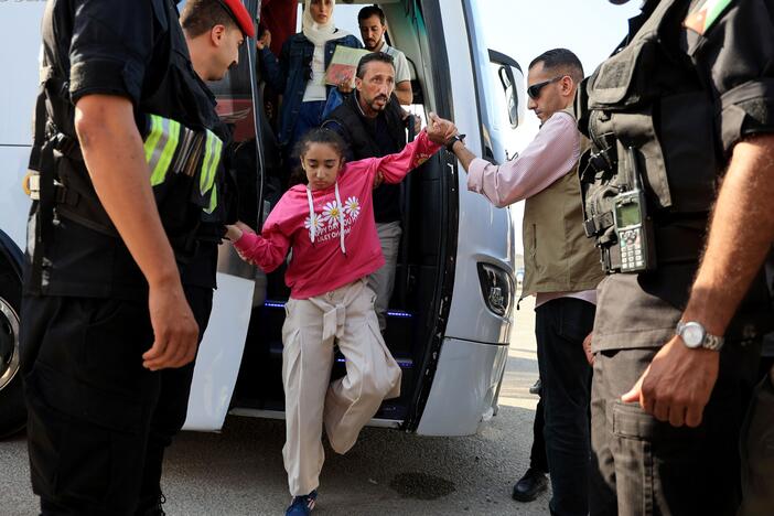 A child gets off a bus near the Jordanian border with other pediatric patients who have been evacuated from Gaza through Israel on June 11.