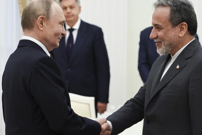 Russian President Vladimir Putin (left) greets Iranian Foreign Minister Abbas Araghchi prior to their talks at the Kremlin in Moscow, Monday.