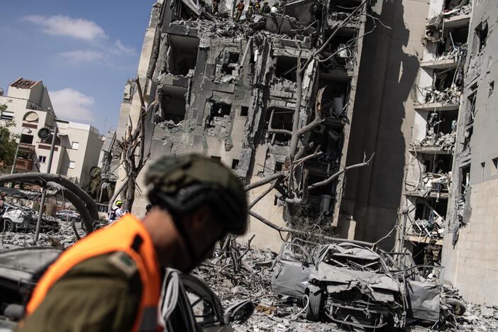 Israeli emergency services and security officers search for casualties in the rubble of a building hit by an Iranian missile in Beersheba in southern Israel on June 24, 2025.