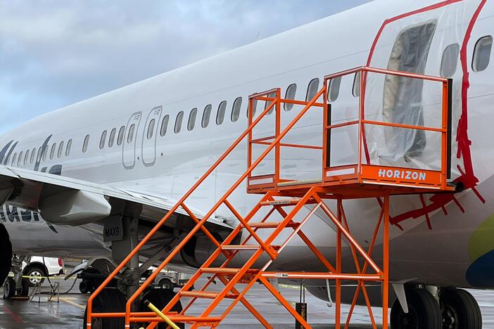 In this National Transportation Safety Board handout photo, plastic covers the exterior of the fuselage plug area of Alaska Airlines Flight 1282, a Boeing 737 Max, on January 7, 2024 in Portland, Ore. A door-sized section near the rear of the plane blew off 10 minutes after takeoff on January 5 on its way to Ontario, Calif.