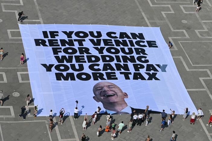 Activists with the international environmental group Greenpeace display a giant banner displaying a picture of Jeff Bezos in Venice's St. Mark's Square on Monday.