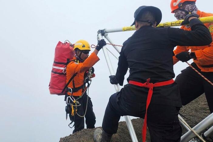 In this undated photo released by the Indonesian National Search and Rescue Agency on Tuesday, June 24, 2025, a rescuer climbs down the ridge of Mount Rinjani during the evacuation operation for Juliana Marins, a Brazilian tourist who fell while hiking near the volcano's summit, in Lombok, Indonesia.
