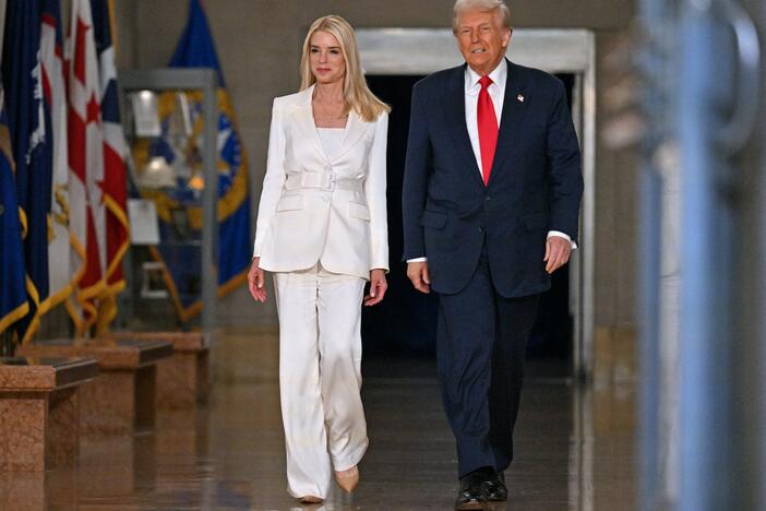 President Donald Trump and Attorney General Pam Bondi arrive to speak at the Department of Justice on March 14, 2025.