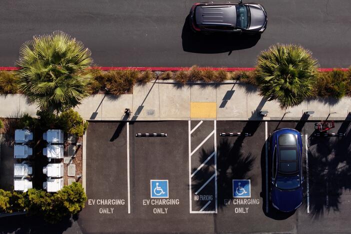 Electric vehicles sit parked at a Tesla charging station in Sausalito, Calif. In 2021 Congress designated $5 billion dollars to pay for high-speed EV chargers along highway corridors. The Trump administration put a pause on the distribution of that money, which a coalition of states have challenged in court. A judge issued a preliminary injunction ordering the funding freeze be lifted for more than a dozen states.