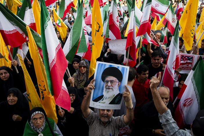 People hold flags of Iran and Hezbollah as well as posters of Supreme Leader Khamenei as Iranians take to the streets in the downtown Enghelab (Revolution) Square in Tehran, Iran on June 24, 2025, to celebrate the ceasefire after a 12-day war with Israel.