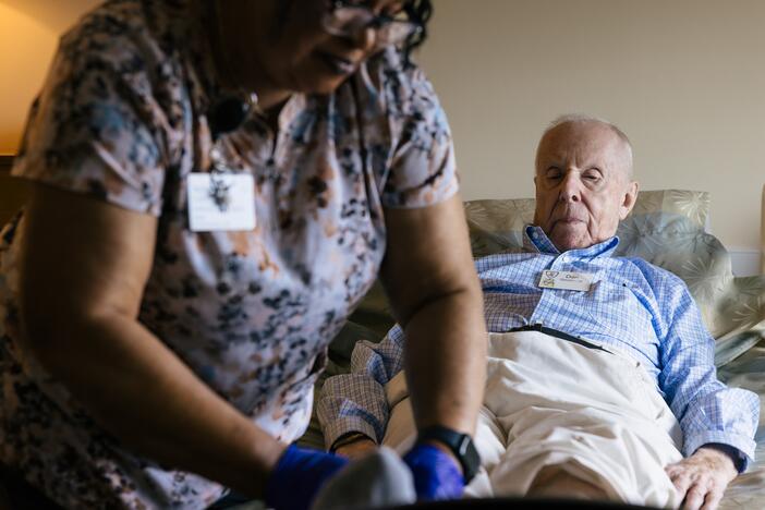 Jackline Conteh, one of many African-born caregivers at the Goodwin House Alexandria nursing home, cares for the Rev. Donald Goodness, 92. Nursing homes are subject to Immigration and Customs Enforcement raids under the Trump administration.