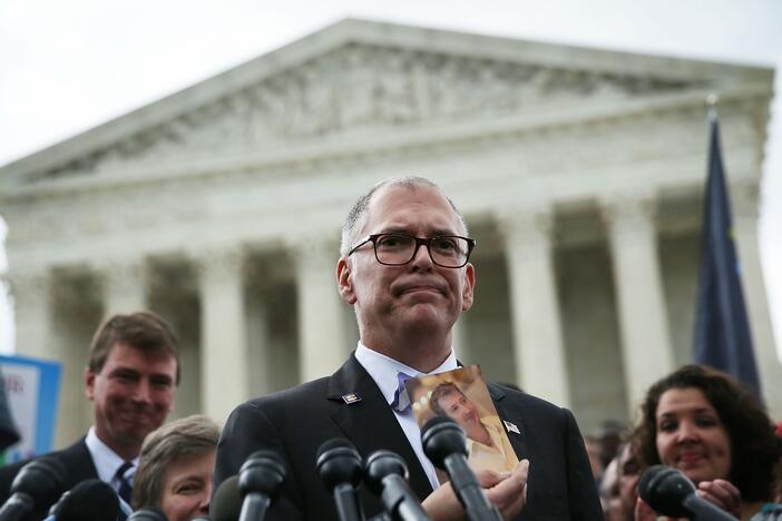 Plaintiff Jim Obergefell holds a photo of his late husband John Arthur as he speaks to members of the media after the U.S. Supreme Court handed down a ruling regarding same-sex marriage June 26, 2015, outside the Supreme Court in Washington, D.C. The high court ruled that same-sex couples have the right to marry in all 50 states.