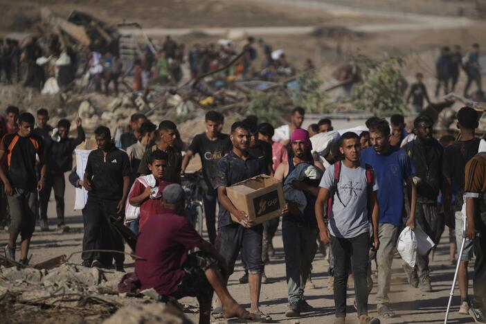 Palestinians carry food packages near a distribution site operated by the U.S.-backed Gaza Humanitarian Foundation in Khan Younis, southern Gaza Strip, Thursday.