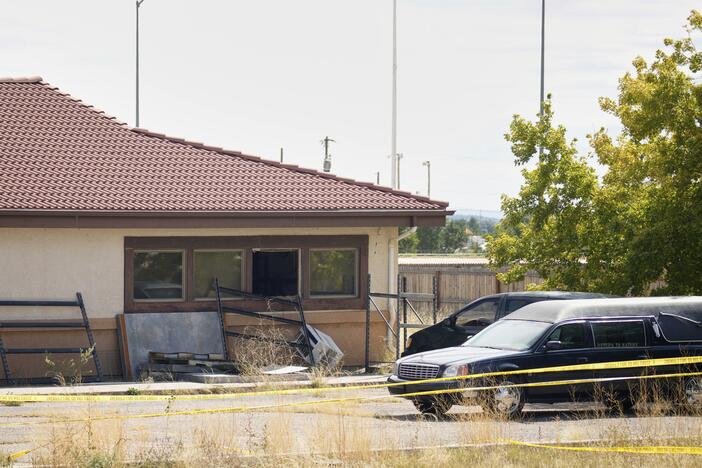 A hearse and van sit outside the Return to Nature Funeral Home in Penrose, Colo., on Oct. 6, 2023.
