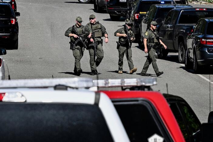 Police and fire crews respond to a shooting and fire on Canfield Mountain in Coeur d'Alene, Idaho, Sunday, June 29, 2025.