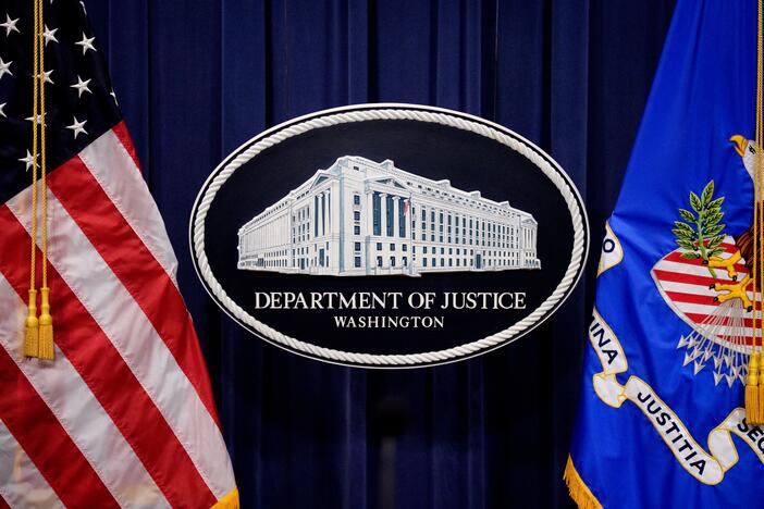 The Department of Justice logo is displayed before U.S. Attorney General Pam Bondi arrives for a news conference at the agency on May 6, 2025 in Washington, DC. The DOJ announced in a June memo that it is aggressively prioritizing efforts to strip some Americans of their U.S. citizenship.