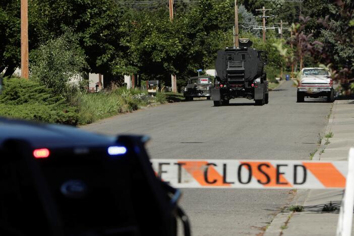 An armored police vehicle travels towards an area where multiple firefighters were attacked when responding to a fire in the Canfield Mountain area on the outskirts of Coeur d'Alene, Idaho, on Sunday.
