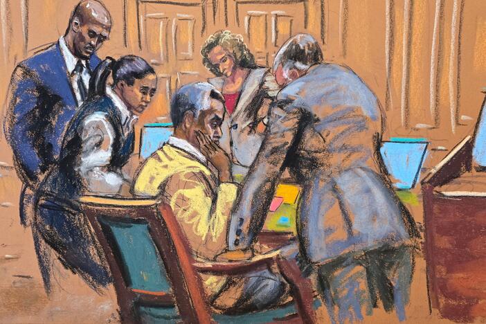 Defense attorneys confer with Sean Combs in this courtroom sketch. The jury began deliberations at Combs' sex trafficking trial in New York City on Monday.