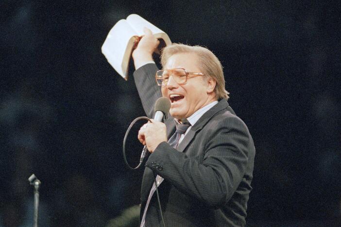 The Rev. Jimmy Swaggart gestures with the Bible at the Los Angeles Sports Arena during a service in Los Angeles in 1987.