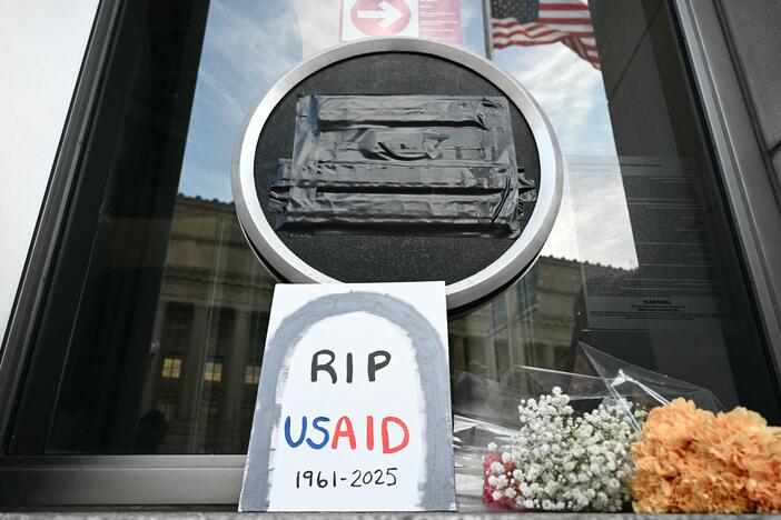 Tributes are placed beneath the covered seal of the United States Agency for International Development (USAID) at their headquarters in Washington, D.C., on February 7, the day that President Donald Trump called for the agency to be shuttered. July 1 marks the agency's official demise.