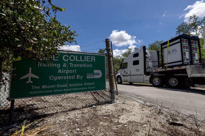 Heavy-duty generators are driven into Dade-Collier Training and Transition Airport last week. Trump is due to visit the site of Florida's newest immigration detention center on Tuesday.