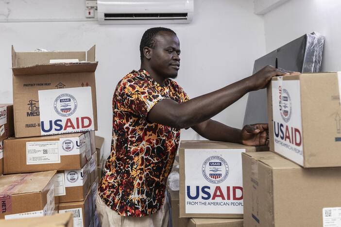 On April 24, Kenyan pharmacist Joseph Njer Airo inspects boxes of antiretroviral drugs labeled "USAID," from the last donation before the funding cuts.
