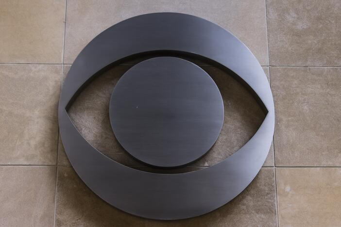 The CBS logo is seen on a building in Chicago. The network's parent company, Paramount Global, has agreed to pay $16 million for President Trump's future presidential library to settle a lawsuit he filed over the editing of a <em>60 Minutes </em>interview with former Vice President Kamala Harris during last fall's elections.