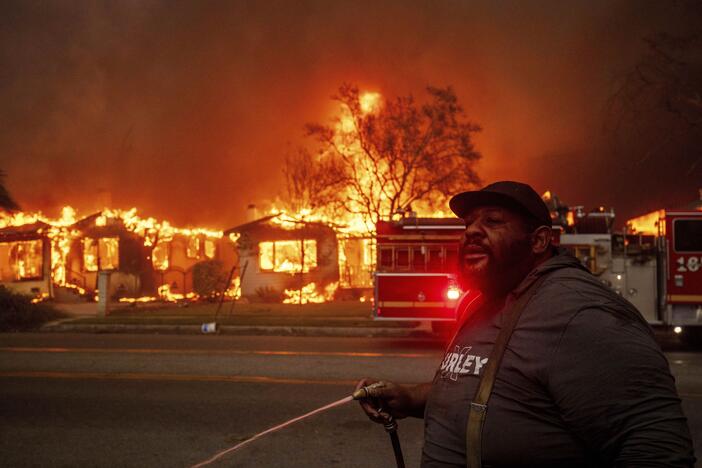 A resident of Altadena, Calif., during wildfires in January 2025. Wildfires are getting more extreme because of climate change. The Trump administration has taken down the website for the National Climate Assessment, which is the most comprehensive and authoritative source of information about how climate change is affecting all parts of the U.S.