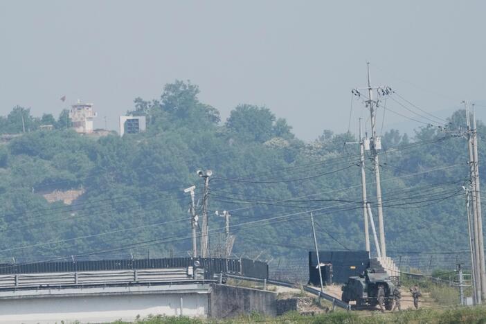 A North Korean military guard post, loudspeaker, top left, and South Korean army soldiers, bottom right, are seen from Paju, South Korea, near the border with North Korea, on June 12.