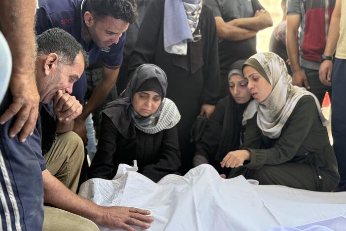 Relatives grieve over bodies of family members killed in an Israeli strike on a school sheltering displaced Palestinians near al-Shifa hospital in Gaza City on Thursday.