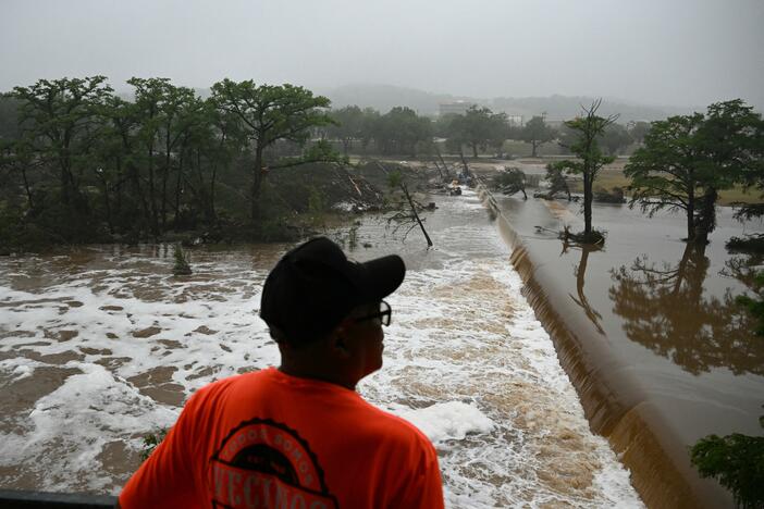 A man looks out at flooding caused by a flash flood at the Guadalupe River in Kerrville, Texas, on Saturday.