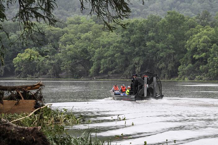 Men ride in an airboat on the Guadalupe River as they look for missing people in Hunt, Texas, on July 6, 2025, following severe flash flooding that occured during the July Fourth holiday weekend.
