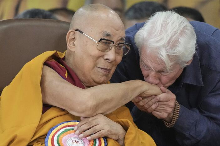 Actor Richard Gere, right, kisses the hand of Tibetan spiritual leader the Dalai Lama at an event celebrating the Dalai Lama's 90th birthday in Dharamshala, India, Sunday.