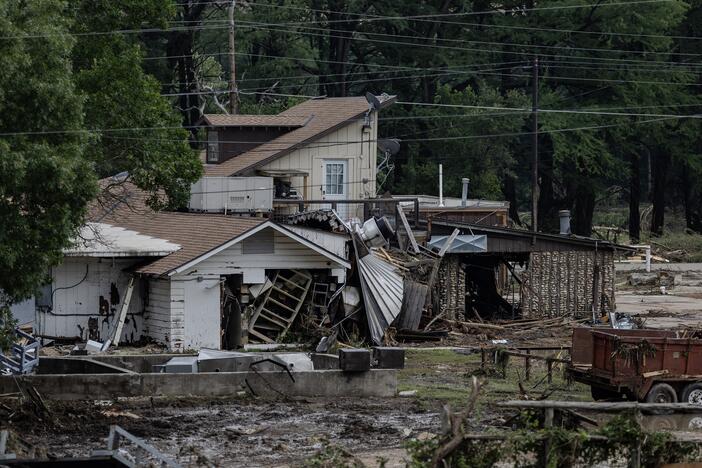A home covered in debris sits near the town center on July 6, 2025, in Hunt, Texas. Heavy rainfall caused flooding along the Guadalupe River in central Texas, with multiple fatalities reported.
