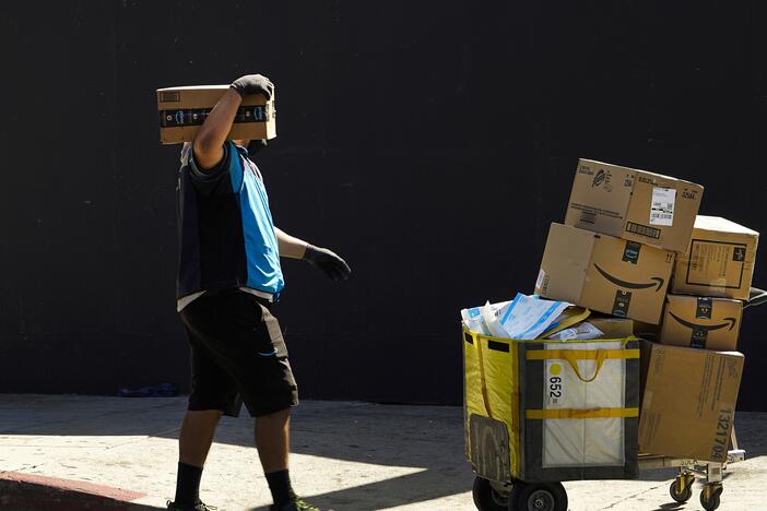 An Amazon worker delivers packages in Los Angeles.