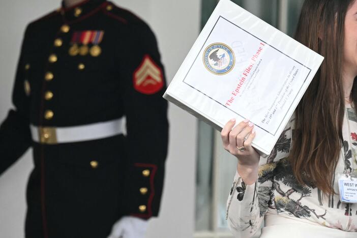Unidentified people carrying binders bearing the seal of the US Justice Department reading "The Epstein Files: Phase 1" walk out of the West Wing of the White House in February. The Trump administration had promised it would release documents on late tycoon and convicted sex trafficker Jeffrey Epstein who was found dead in his prison cell in 2019.