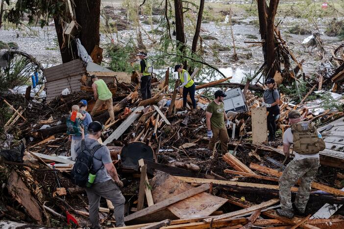 Search and rescue workers dig through debris looking for any survivors or remains of people swept up in the flash flooding on July 6, in Hunt, Texas.