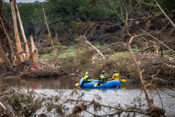 A search and recover unit paddles along the Guadalupe River on Monday in Hunt, Texas. Heavy rainfall caused severe flash flooding along the Guadalupe River in central Texas.