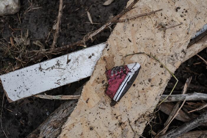 A baby shoe lays along the Guadalupe River after it was swept up in the flash flooding in Ingram, Texas.
