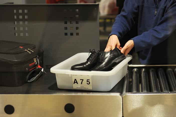 An air traveler puts his shoes in a bin before passing through a Transportation Security Administration (TSA) security checkpoint at Los Angeles International Airport in 2014.