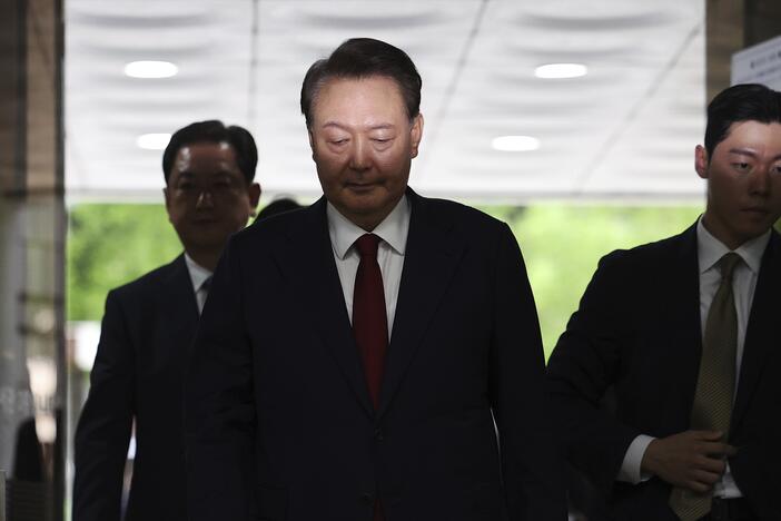 Former South Korean President Yoon Suk Yeol, centerm arrives at a court to attend a hearing to review his arrest warrant requested by special prosecutors in Seoul, South Korea Wednesday, July 9, 2025.