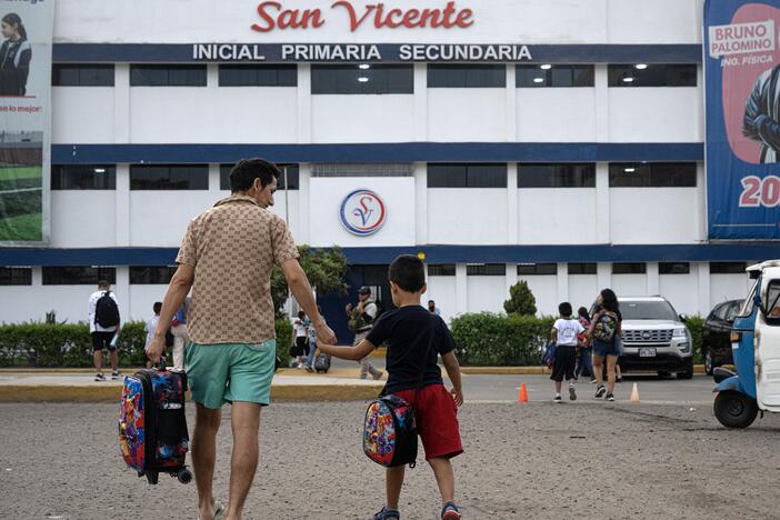 Parents drop off their children at the private San Vicente School in Lima, Peru, which was targeted for extortion, in April.