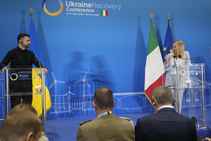 Ukraine's President Volodymyr Zelenskyy and Italian Prime Minister Giorgia Meloni speak with media reporters during the Ukraine Recovery Conference at La Nuvola convention center in Rome on Thursday.