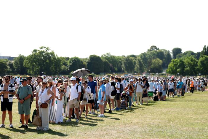 Spectators wait in the Queue on day one of Wimbledon, June 30.