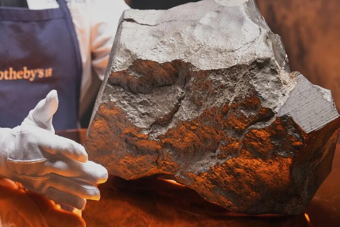 A Martian meteorite said to be the largest piece of Mars on Earth, estimated at $2 - 4 million, is displayed at Sotheby's, in New York.