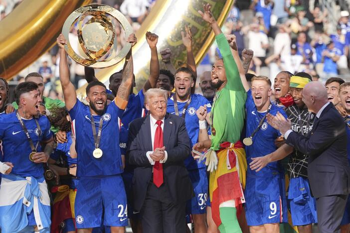 Chelsea's Reece James (24) lifts the trophy as President Donald Trump looks on following the Club World Cup final soccer match between Chelsea and PSG in East Rutherford, N.J. on Sunday.