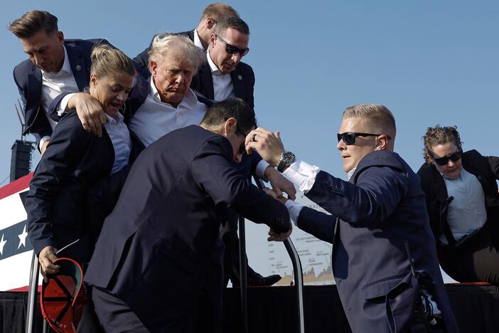 Then-candidate Donald Trump is rushed offstage by U.S. Secret Service agents after being struck by a bullet during a rally on July 13, 2024, in Butler, Pa.