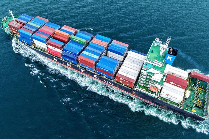 A cargo ship loaded with containers leaves the port in Qingdao, in eastern China's Shandong province on July 8.
