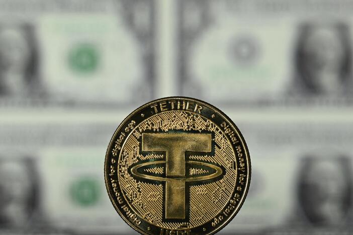 An illustration picture taken in London on May 8, 2022, shows a souvenir Tether (USDT) coin, which is one of the world's biggest stablecoins.