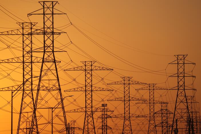 A view of high-voltage transmission towers in Houston. The law President Trump signed on July 4 ends tax incentives for wind and solar projects and is expected to drive up electricity bills across the U.S., according to a nonpartisan think tank.
