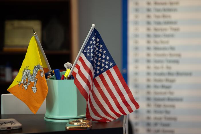 A Bhutanese and American flag are displayed on the desk of a business in Harrisburg, PA on April 16. This is not the first time that Nepali-speaking Bhutanese refugees have faced questions about citizenship and belonging. Some 30 years ago, they were branded as illegal immigrants by the Bhutanese government and were expelled or forced to flee.